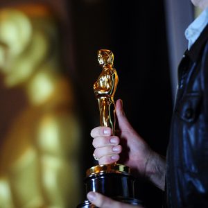 2012-02-22 09:16:52 A New York Oscar fan holds an Oscar statuette stands during the opening ceremony of the "Meet the Oscars, Grand Central" exhibition at Grand Central Station in New York, February 22, 2012. Academy Award Winner Melissa Leo opened the exhibition which allow fans in New York to see and hold actual Oscar statuettes ahead of the 84th Academy awards scheduled for February 26, 2012. AFP PHOTO/Emmanuel Dunand