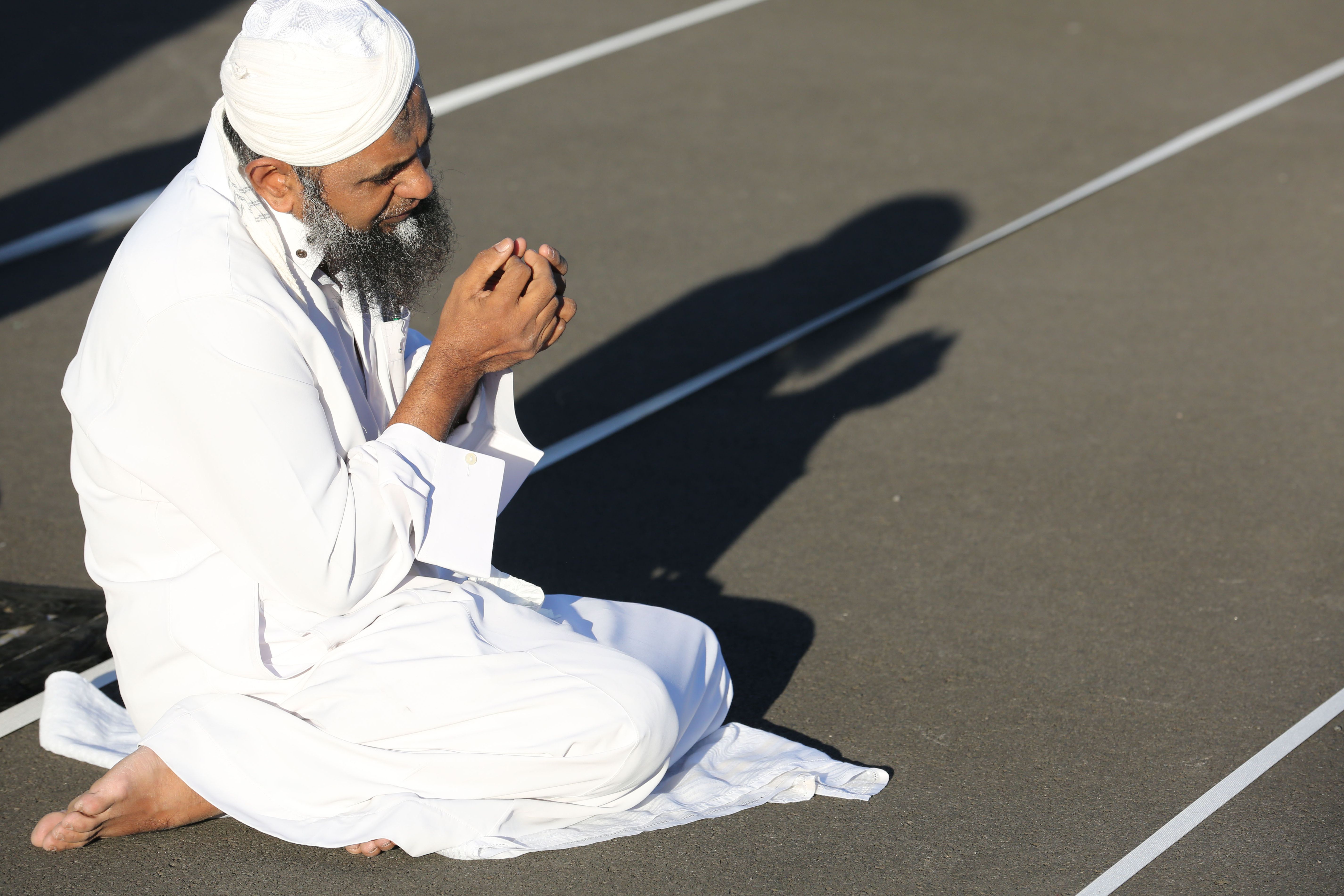 2016-07-06 00:04:32 A man prays during a large communal prayer at the velodrome of Saint-Denis de la Reunion on the French island of Reunion in the Indian Ocean on July 6, 2016, as Muslims celebrate Eid al-Fitr, which marks the end of the fasting month of Ramadan. / AFP PHOTO / RICHARD BOUHET